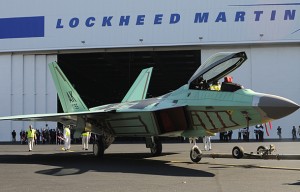 The final F-22 Raptor fighter jet rolls out of the assembly plant during a ceremony marking the occasion at the Lockheed Martin Plant in Marietta , Georgia, in this December 13, 2011, file photo. Lockheed Martin Corp, the largest U.S. weapons maker, on October 24, 2012, posted an 11 percent increase in third-quarter earnings, beating expectations by a wide margin, and raised its full-year forecast. REUTERS/Tami Chappell/Files (UNITED STATES - Tags: MILITARY TRANSPORT BUSINESS)
