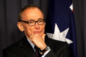 Former NSW premier Bob Carr listens at a press conference with Prime Minister Julia Gillard in Canberra, Friday, March. 2, 2012. Ms Gillard announced that Mr Carr would take the vacant senate seat and become foreign minister of Australia. (AAP Image/Alan Porritt) NO ARCHIVING