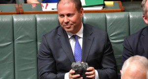 Minister for Environment Josh Frydenberg with a lump of coal during Question Time in the House of Representatives at Parliament House in Canberra, Thursday, Feb. 9, 2017. (AAP Image/Mick Tsikas) NO ARCHIVING